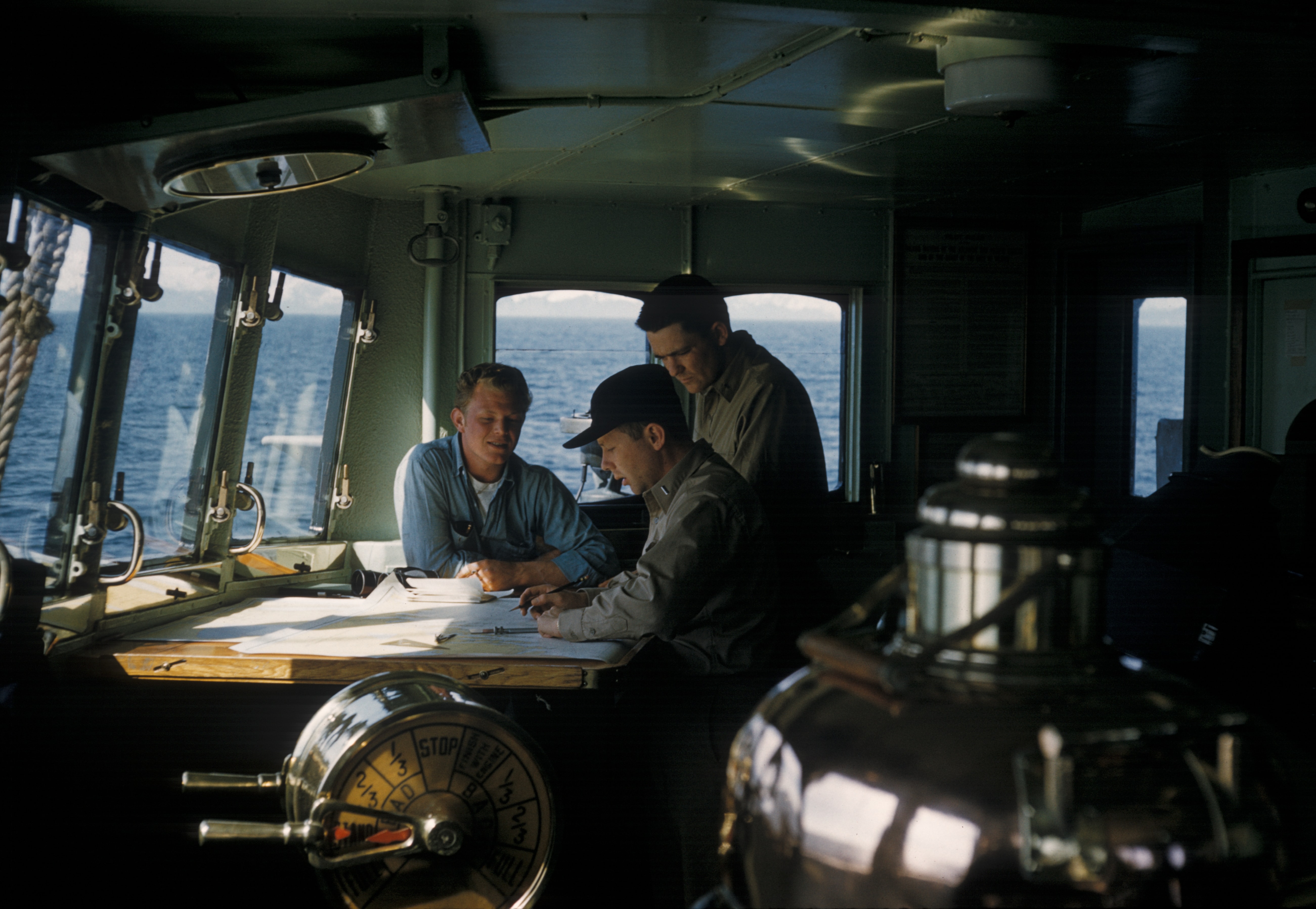 people at controls of ship