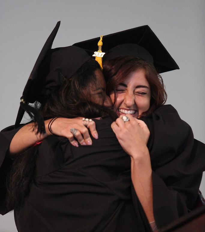 Hampshire College women hugging at commencement