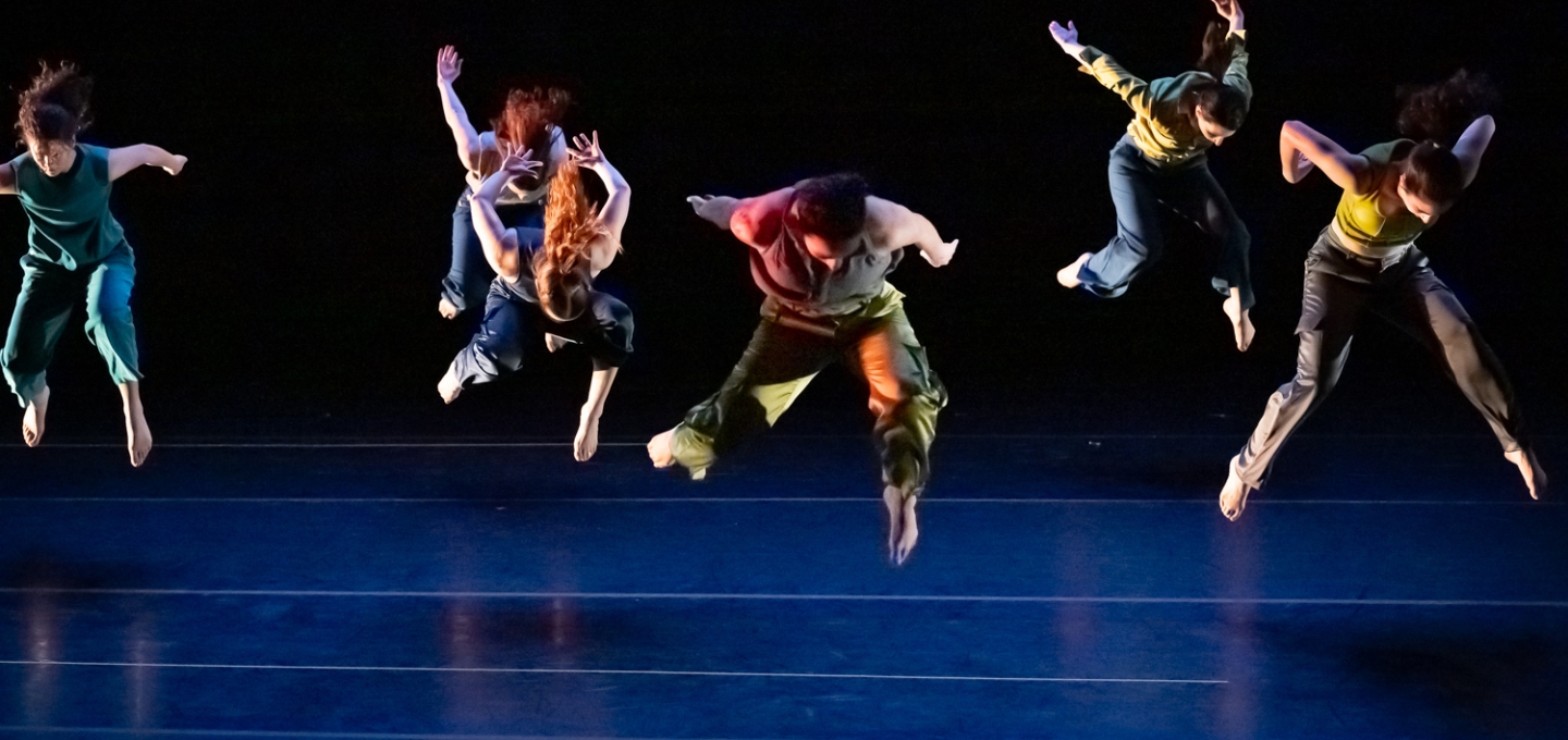 Dancers jump in unison photo by Derek Fowles