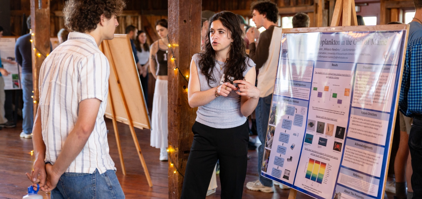 Student showing her poster at the Coastal Marine Science Poster Session 2025