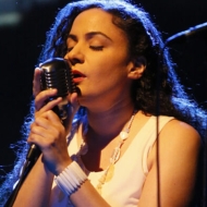 Jennifer Kreisberg singing with a microphone