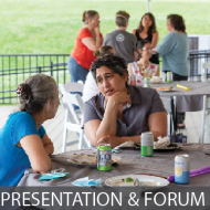 Two people sitting at table in conversation, text below reads "Presentation & Forum"