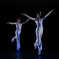 Two dancers in white sautee in unison. photo by Paul Bloomfield of Lucinda Childs's Dance 1 (1979)