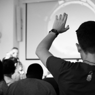 person raising their hand to ask a question
