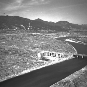 An aeriel view of a bridge with mountains in the background.