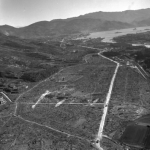 An aerial view of an airstrip and highway.
