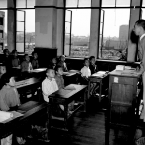 A classroom with a teacher instructing his students.