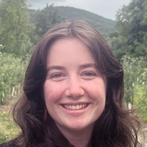Portrait of Brigid Mullen with an orchard in the background