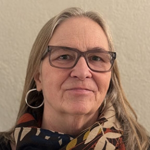 Portrait of Beth Mattison, with a cream background