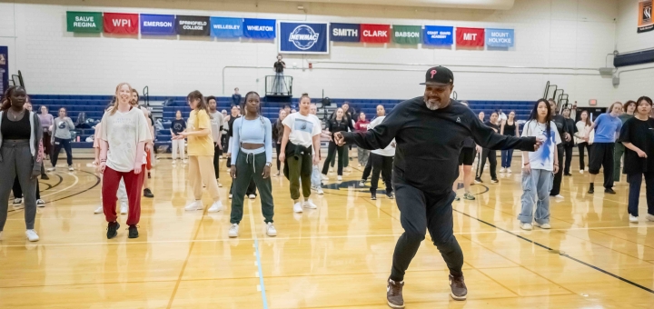 Rennie Harris demonstrates a hip hop move for a masterclass in the gym at Smith College. Photo by Derek Fowles.