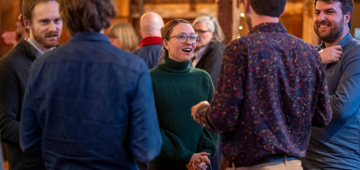 faculty members having a discussion during a reception